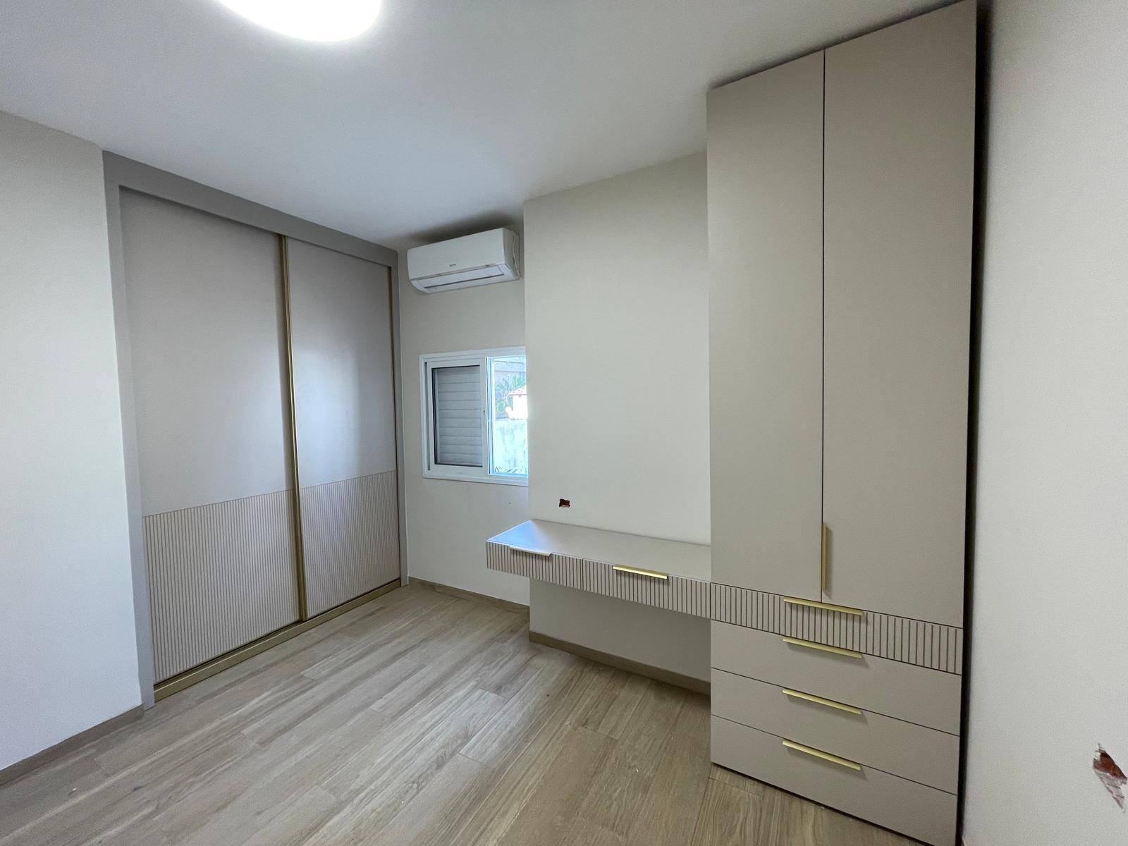 ארון הזזה וארון אחסון לחדר ילדים בעיצוב יוקרתי עם חירוץ עדין ושילובי זהב ושולחן עבודה מובנה